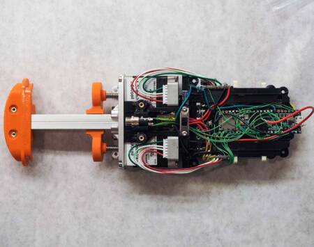 A prototype of a syringe pump with the cover removed.