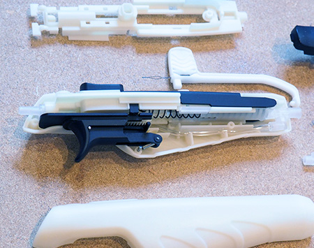 A medical device with a cover removed so we can see the internal mechanism